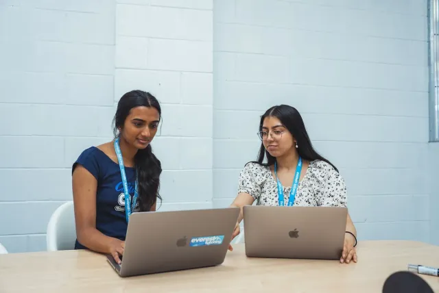 Two Everest students working on laptops